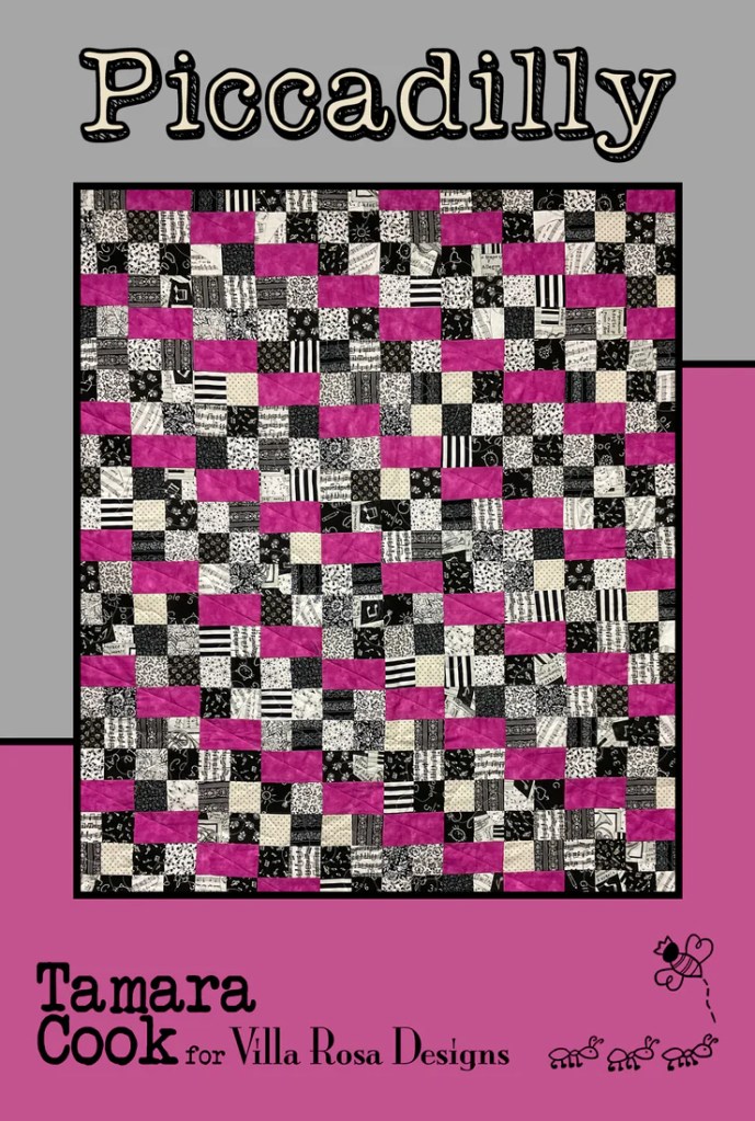 A colorful quilt design titled 'Piccadilly' by Tamara Cook for Villa Rosa Designs, featuring a pattern of black, white, and pink squares in a checkerboard layout.