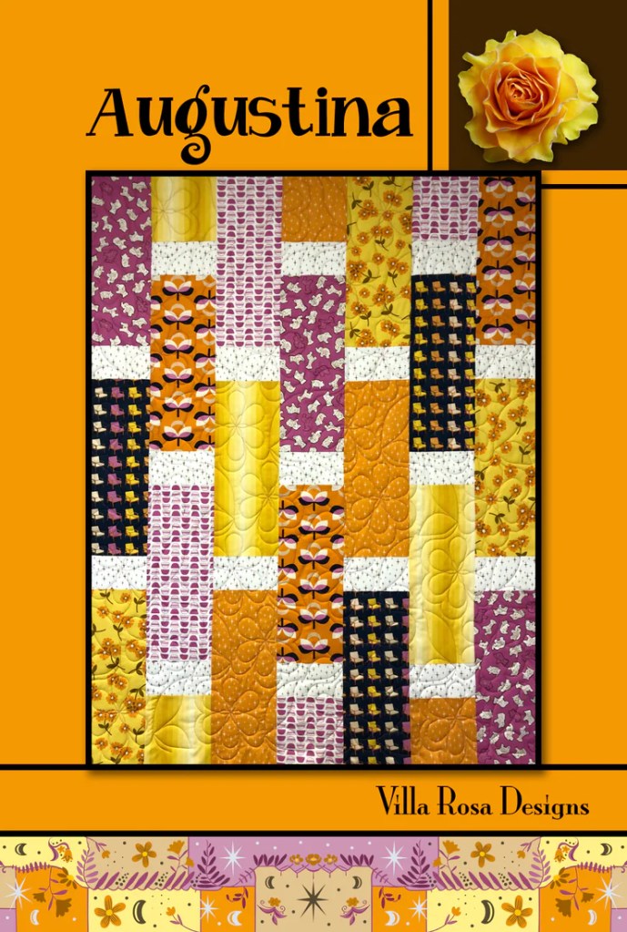 A vibrant quilt pattern titled 'Augustina' featuring colorful fabric blocks in shades of purple, yellow, and orange, with floral and geometric designs. The quilt is displayed on a warm orange background, showcasing its cheerful and lively aesthetic.