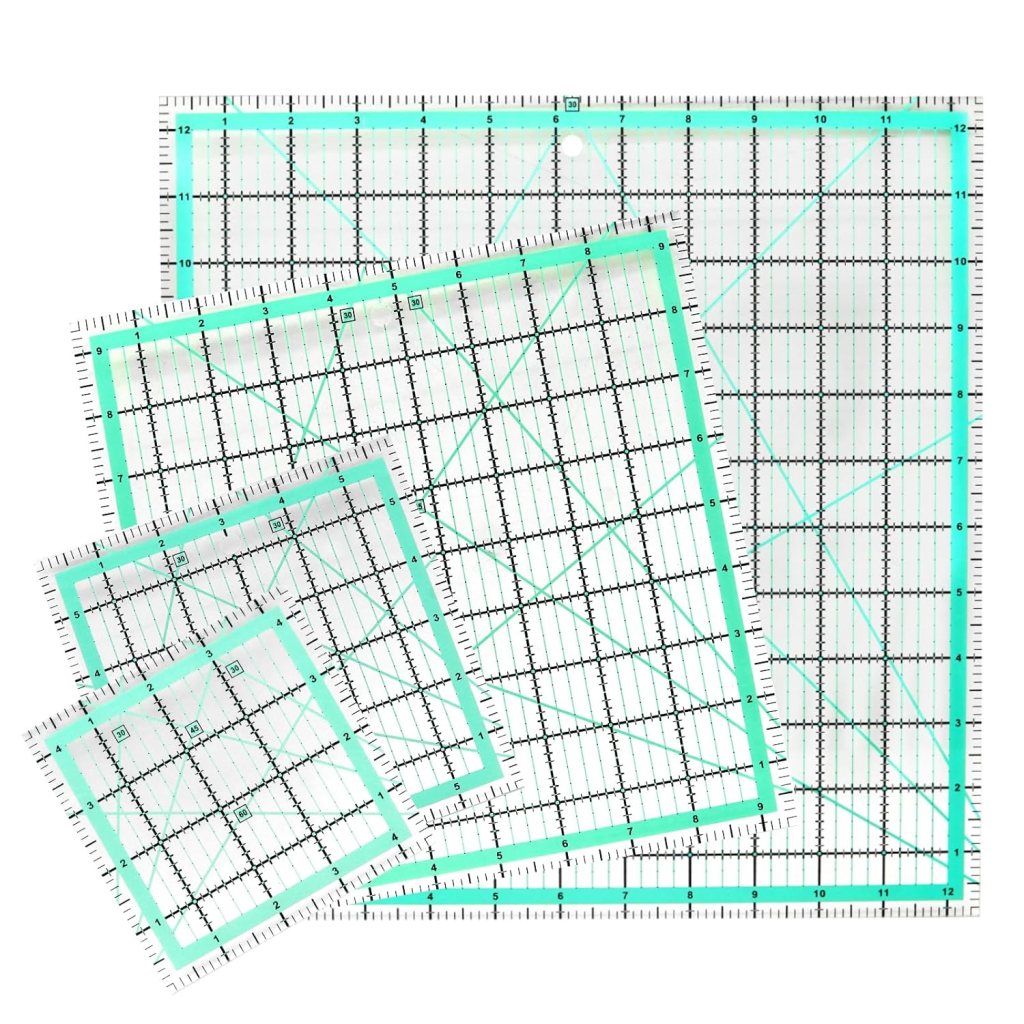 A set of clear quilting rulers in various sizes, featuring measurement grids and markings, placed on a white background.