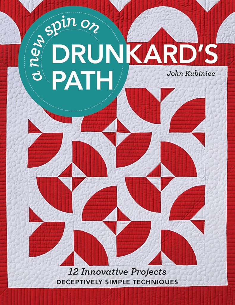Book cover of 'A New Spin on Drunkard's Path' by John Kubiniec, featuring a quilt design in red and white with a pattern of curved shapes and geometric accents.