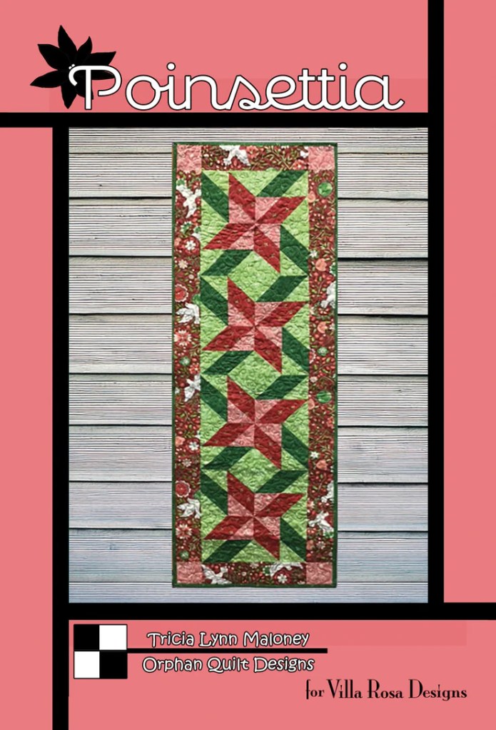 A vibrant quilt pattern featuring red and green poinsettias, displayed on a pink background with a decorative border.
