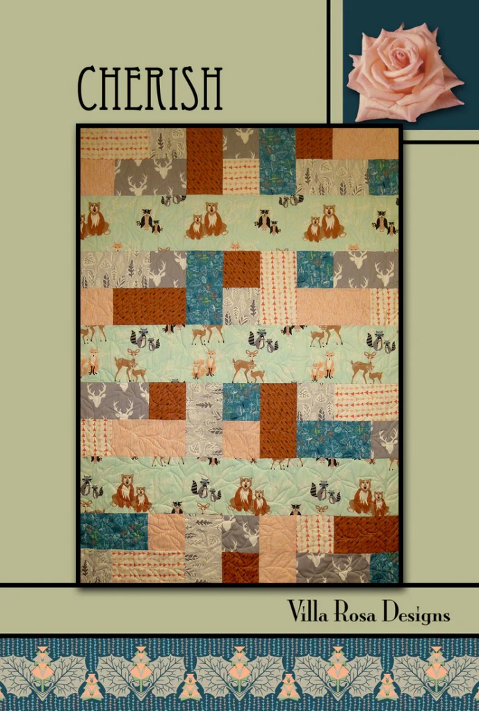 A quilt titled 'Cherish' featuring a patchwork design with bear and woodland animal motifs, in a color palette of soft greens, browns, and blues, created by Villa Rosa Designs.