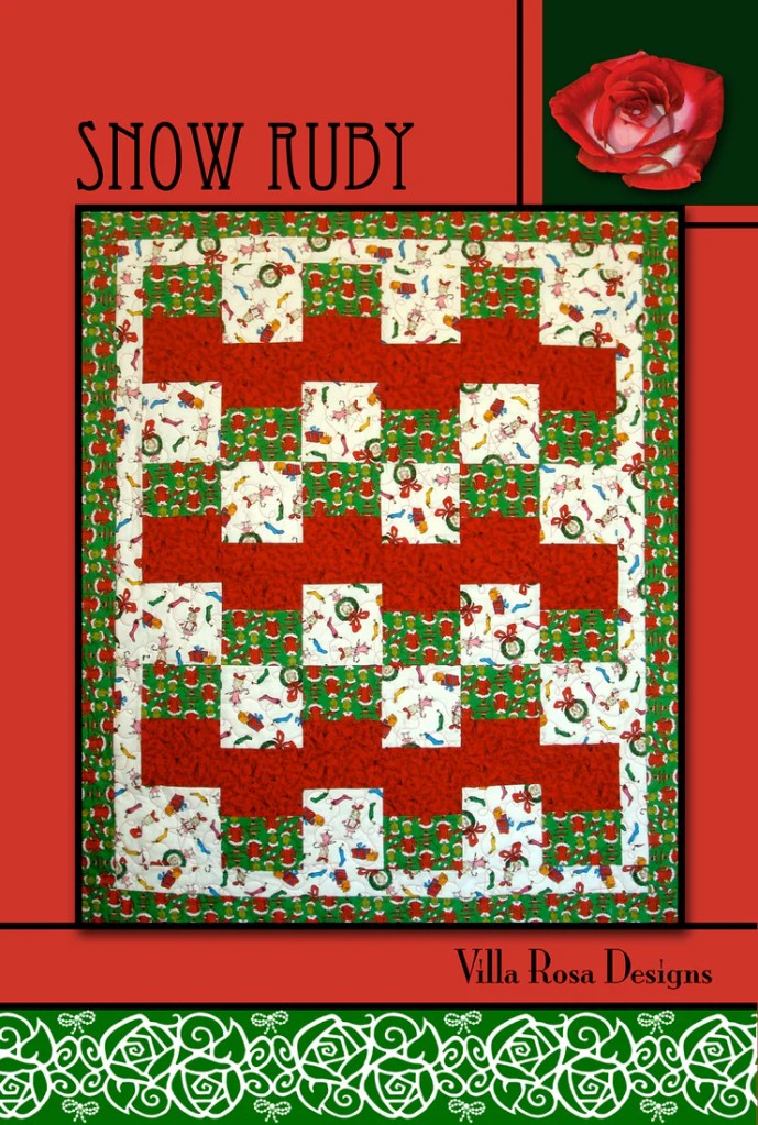A quilt titled 'Snow Ruby' featuring a festive red and green color scheme with playful holiday-themed patterns, bordered by intricate designs, showcasing the Villa Rosa Designs logo.