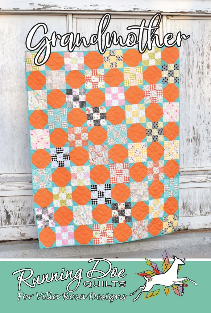Colorful quilt design titled 'Grandmother' featuring a pattern of patterned squares and orange accents, displayed against a rustic backdrop.
