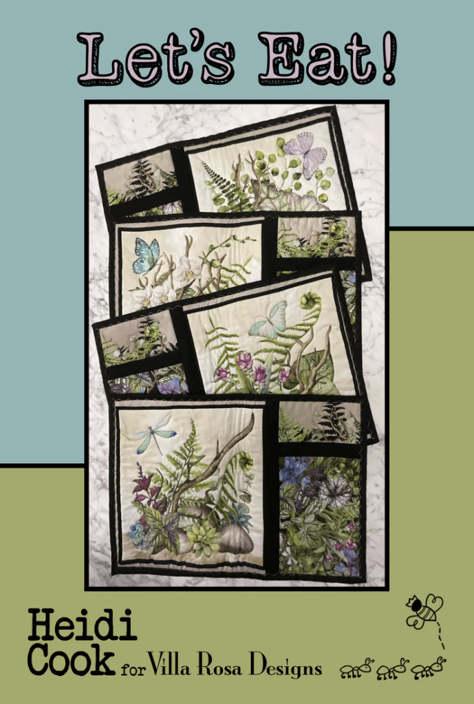 A visually appealing sewing pattern cover titled 'Let's Eat!' featuring several quilted place mats with botanical designs, including butterflies and ferns, framed in black. The design promotes holiday cooking and gatherings.