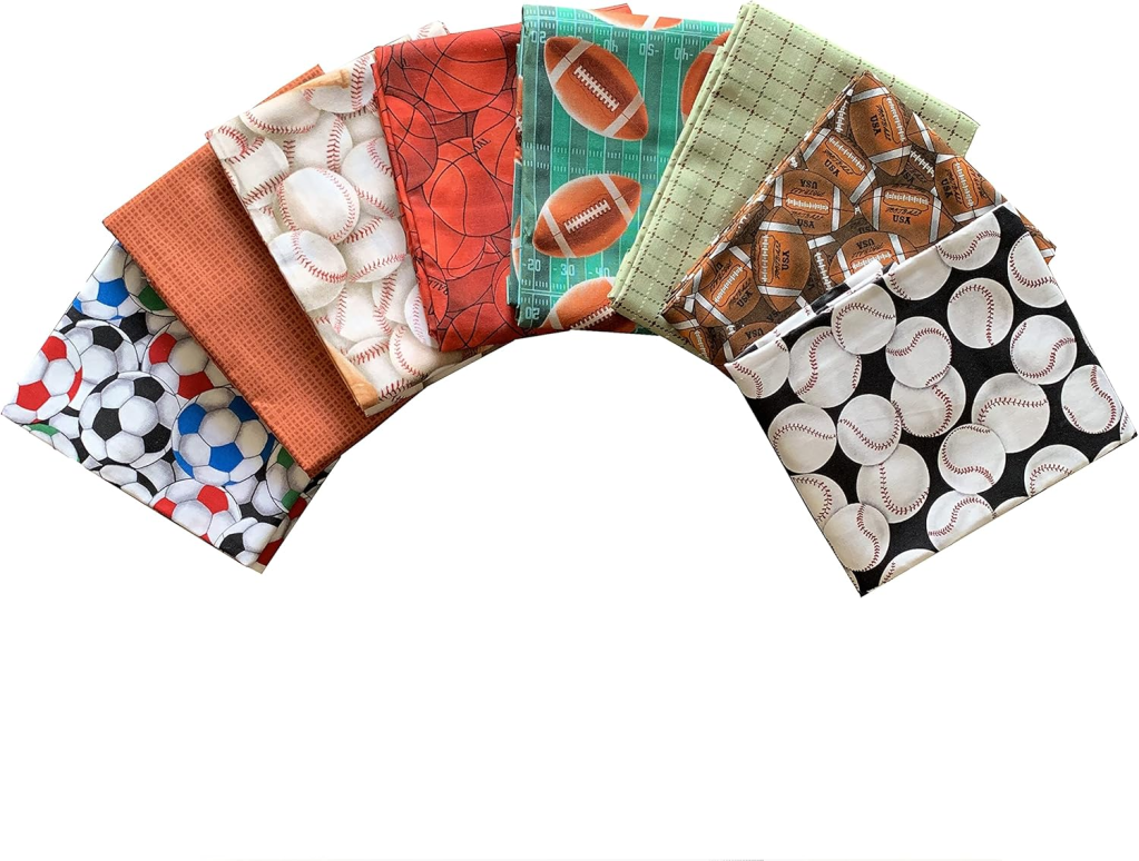 A variety of fabric pieces featuring sports themes, including soccer, baseball, basketball, and football patterns, arranged in a fan shape.