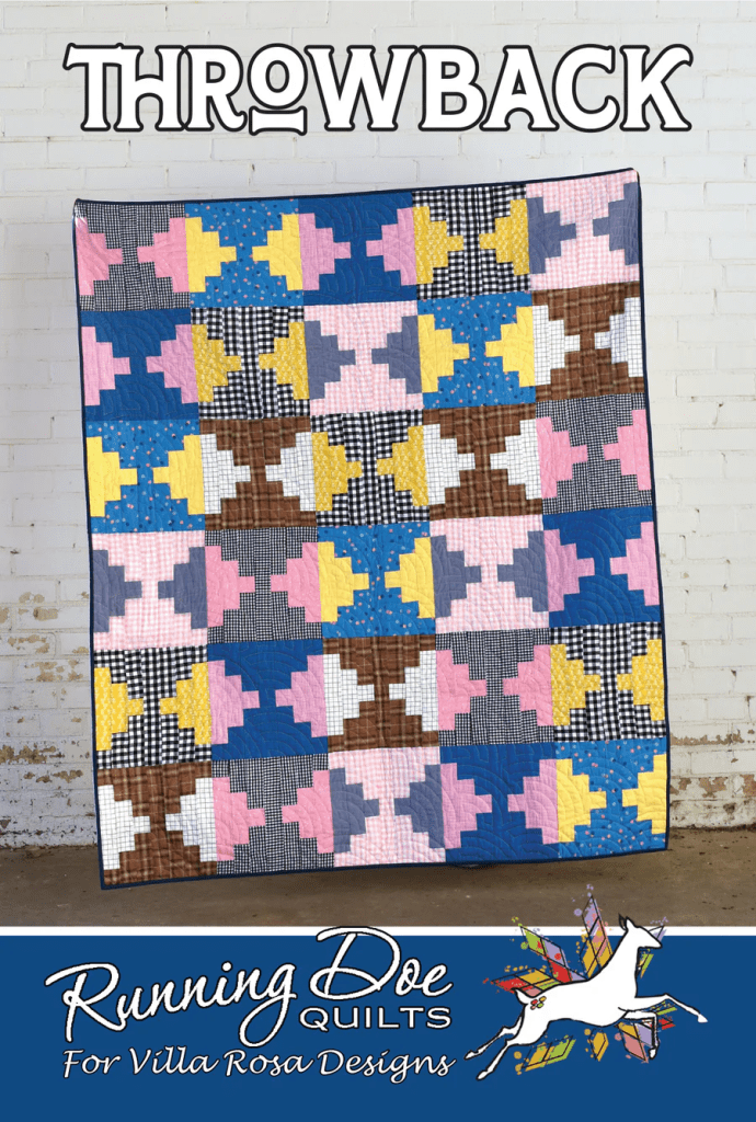 A colorful quilt featuring a geometric pattern of yellow, pink, blue, and brown shapes displayed against a white brick wall, with the text 'THROWBACK' above and 'Running Doe Quilts for Villa Rosa Designs' below.