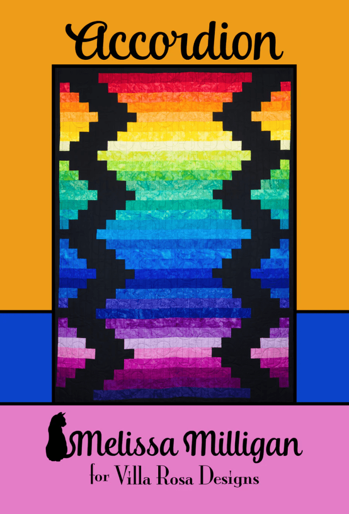 A vibrant quilt titled 'Accordion' designed by Melissa Milligan for Villa Rosa Designs, featuring a colorful pattern with stripes in shades of rainbow colors against a black background.