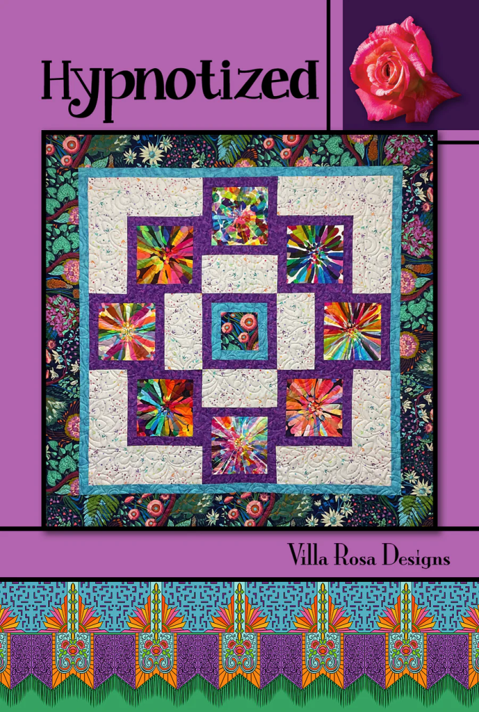 A vibrant quilt design titled 'Hypnotized' by Villa Rosa Designs, featuring colorful geometric patterns set against a purple background with floral accents.