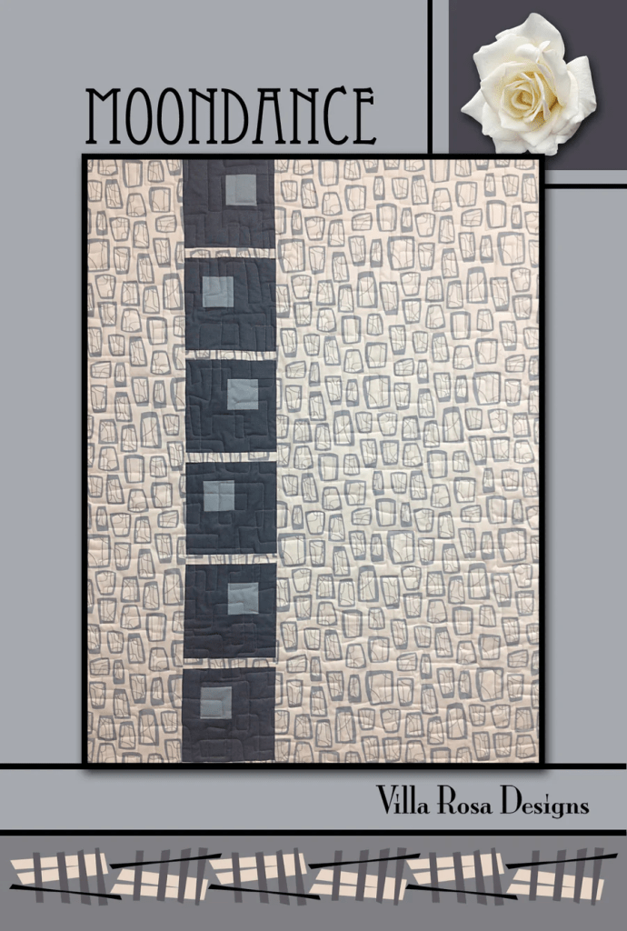 A quilt titled 'Moondance' by Villa Rosa Designs, featuring a modern pattern with gray and beige colors, highlighted with squares and a decorative border.