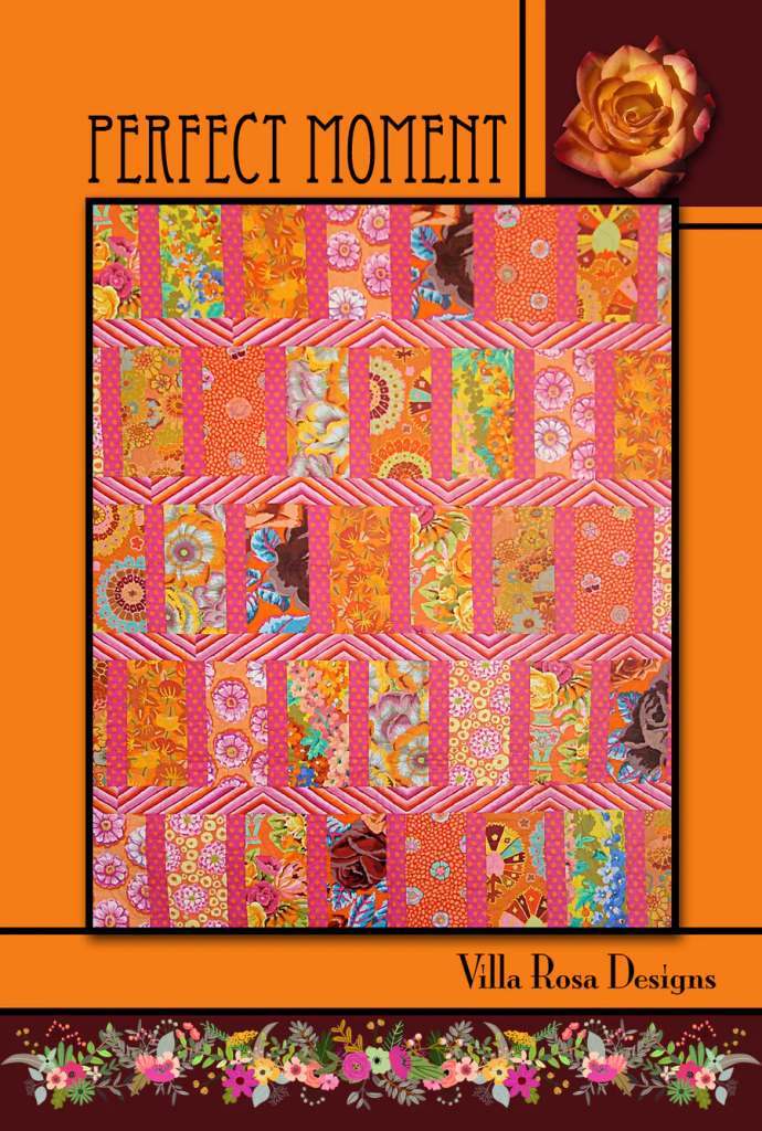Colorful quilt design featuring vibrant floral patterns and geometric shapes, titled 'Perfect Moment' by Villa Rosa Designs.