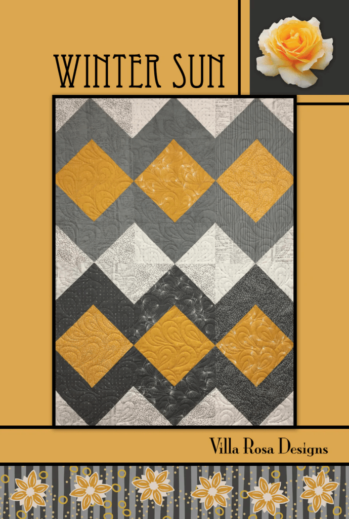 A quilt design titled 'Winter Sun' featuring a pattern of alternating gray, white, and mustard yellow diamonds, with intricate quilting details. The background includes a rose graphic and decorative floral elements at the bottom.