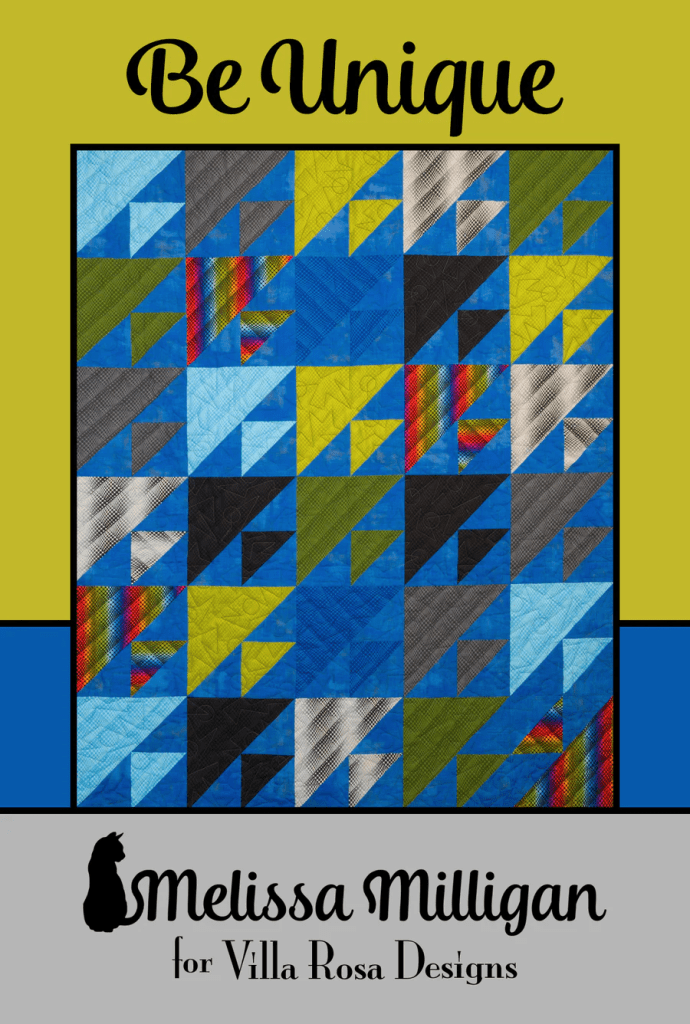 A colorful quilt design featuring various geometric patterns in shades of blue, gray, green, and red, with a title 'Be Unique' and designer credit to Melissa Milligan for Villa Rosa Designs.