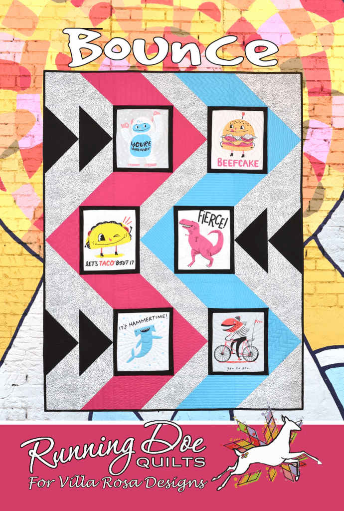 A colorful quilt titled 'Bounce' featuring playful illustrations and humorous phrases on fabric squares against a patterned background.