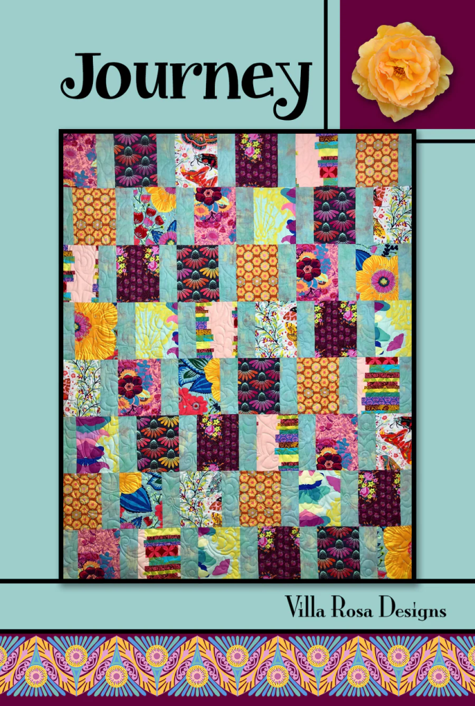 Colorful quilt design titled 'Journey' by Villa Rosa Designs, featuring a pattern of various floral and geometric prints arranged in a patchwork style.