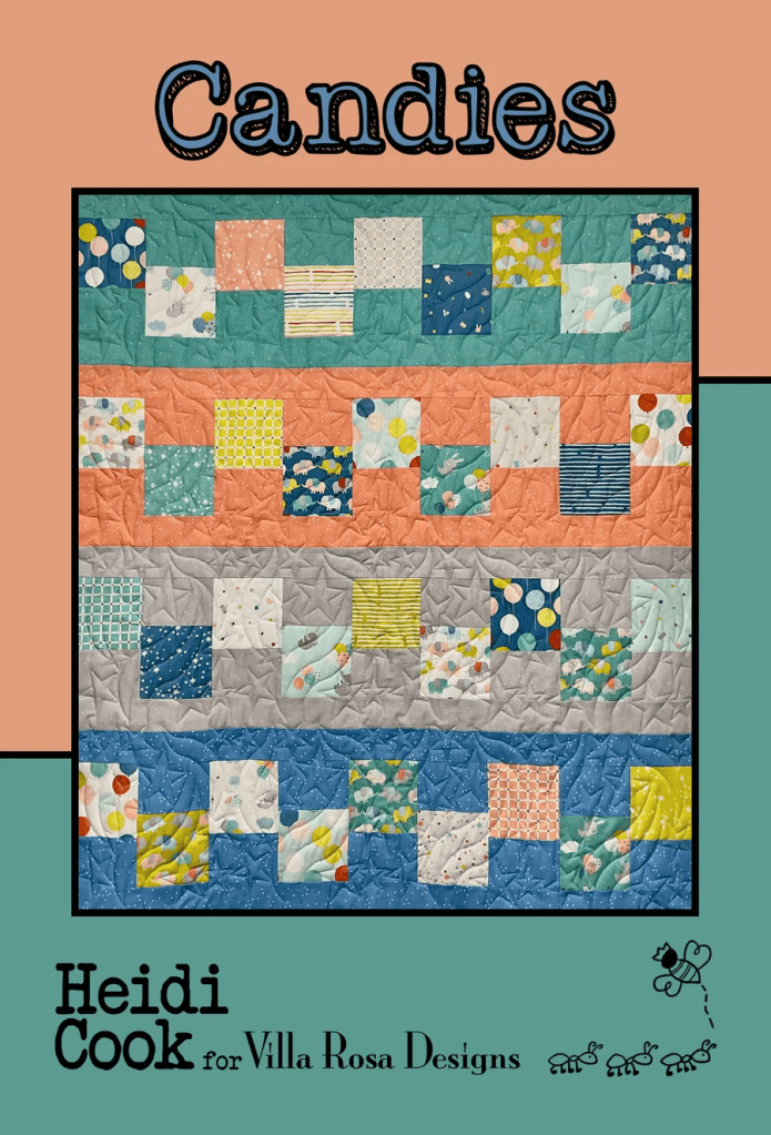 A colorful quilt titled 'Candies' featuring a patchwork design with various patterned squares in pastel colors, created by Heidi Cook for Villa Rosa Designs.