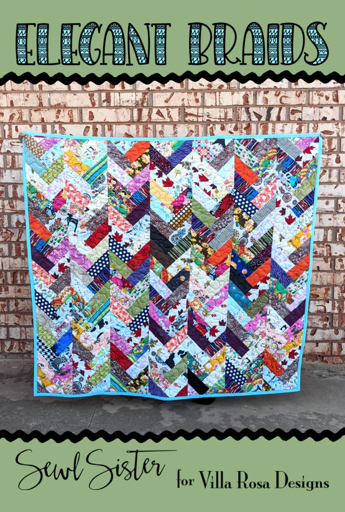 A colorful quilt titled 'Elegant Braids' featuring a zigzag design made from various patterned fabrics, displayed against a brick wall.