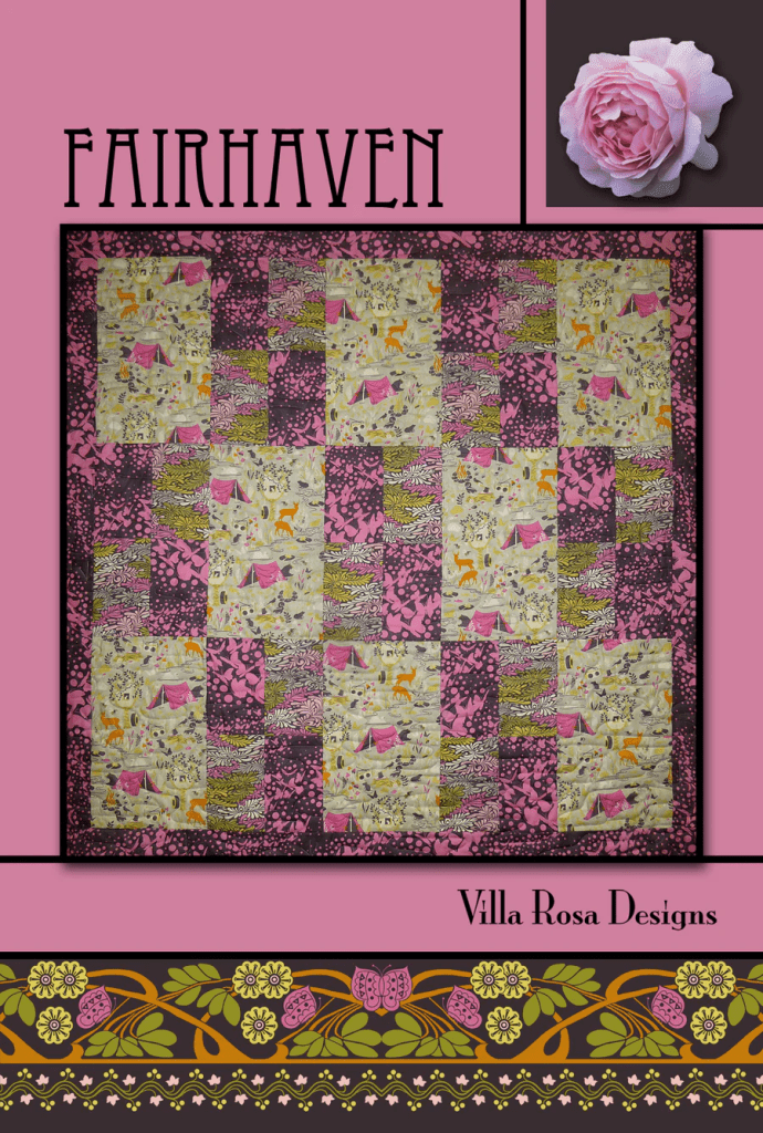 A colorful patchwork quilt featuring a mix of floral and animal patterns in pink, green, and yellow shades, titled 'Fairhaven' by Villa Rosa Designs.