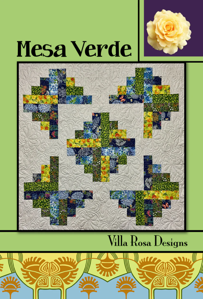 A colorful quilt design titled 'Mesa Verde' featuring abstract patterns in various shades of blue and green, with floral motifs, against a light beige background. The design is accompanied by branding for 'Villa Rosa Designs' and a decorative floral image.