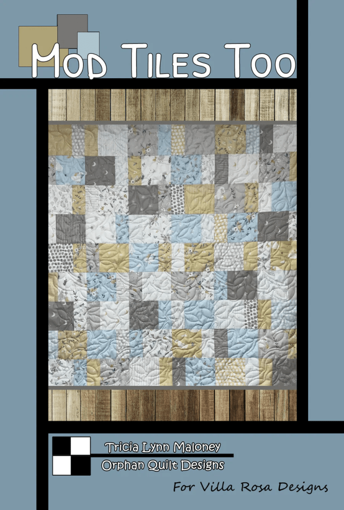 A quilt design featuring a patchwork layout with various shades of blue, gray, and yellow fabrics. The quilt is surrounded by a simple wooden border and includes text indicating the title 'Mod Tiles Too' along with the designer's name and affiliation.