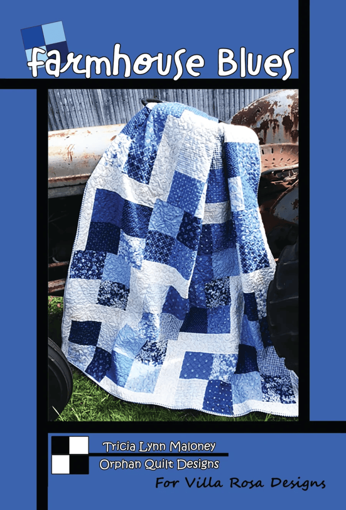Cover image of a quilt titled 'Farmhouse Blues,' featuring a blue and white patchwork design draped over an old tractor. The background includes a weathered metal backdrop.