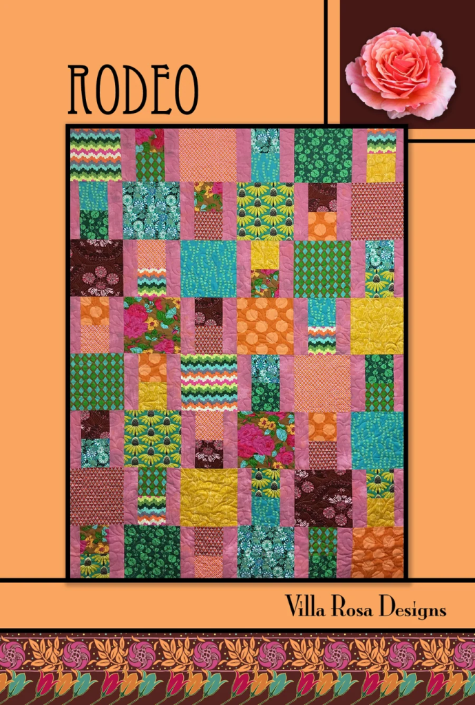 Colorful quilt design featuring various patterned fabric squares and rectangles in vibrant colors, titled 'RODEO' by Villa Rosa Designs.