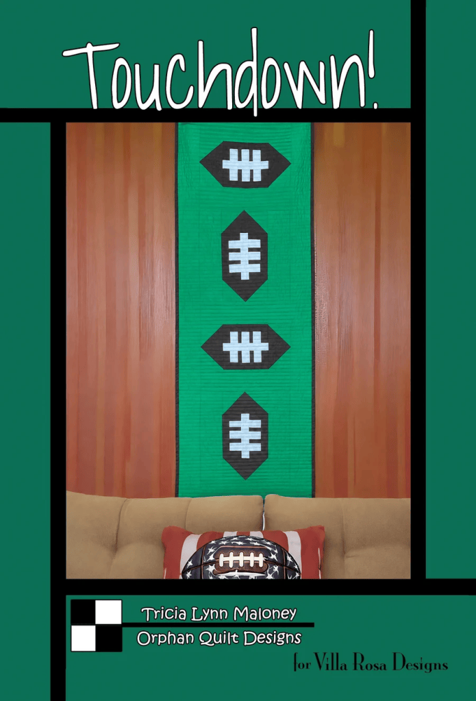A quilt design featuring football shapes on a green background, with the text 'Touchdown!' at the top, and a decorative couch with an American flag football and a bag beside it.