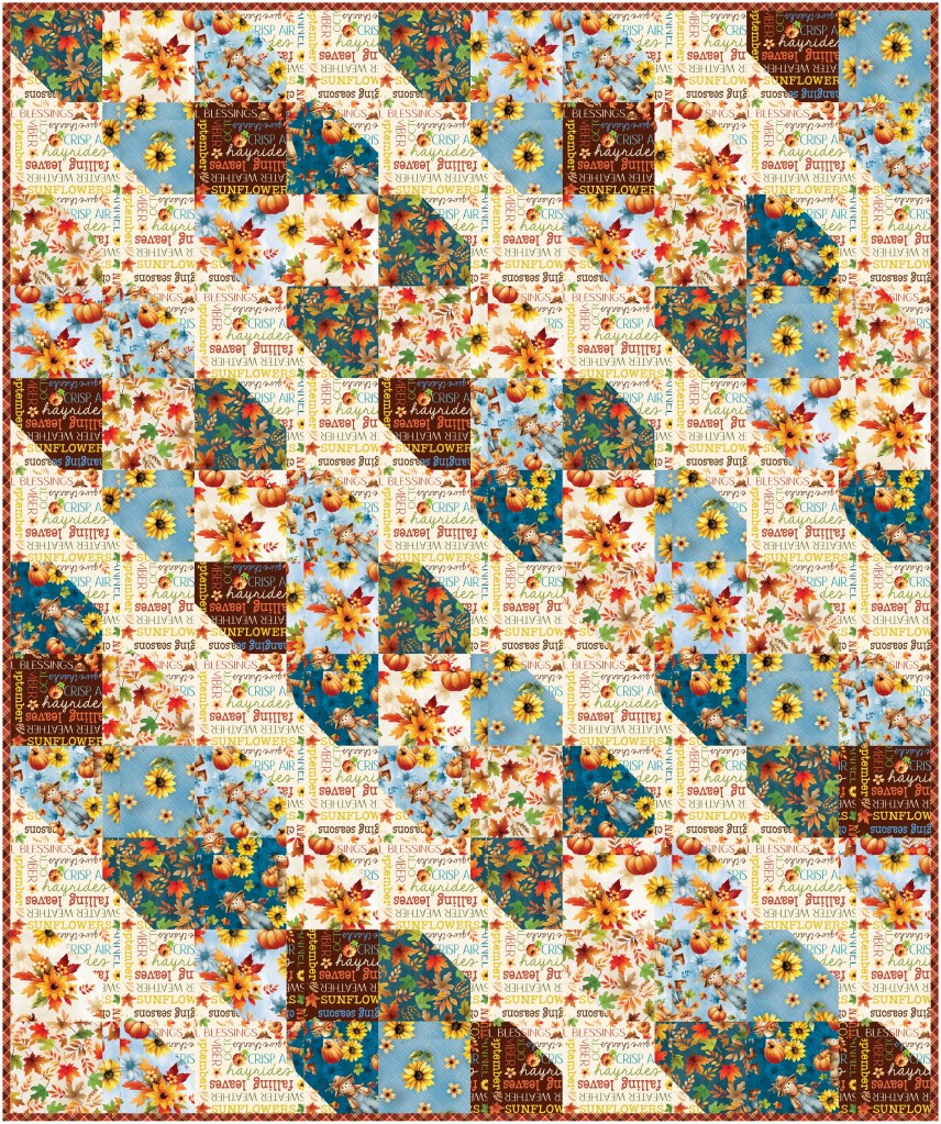 A colorful quilt featuring a patchwork of floral and seasonal prints, including sunflowers, leaves, and decorative text patterns.